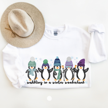 Load image into Gallery viewer, Waddling In A Winter Wonderland Women's Unisex Crewneck Sweatshirt Cute Winter Penguins in Hats and Scarves Funny Winter