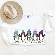 Load image into Gallery viewer, Waddling In A Winter Wonderland Women&#39;s Unisex Crewneck Sweatshirt Cute Winter Penguins in Hats and Scarves Funny Winter
